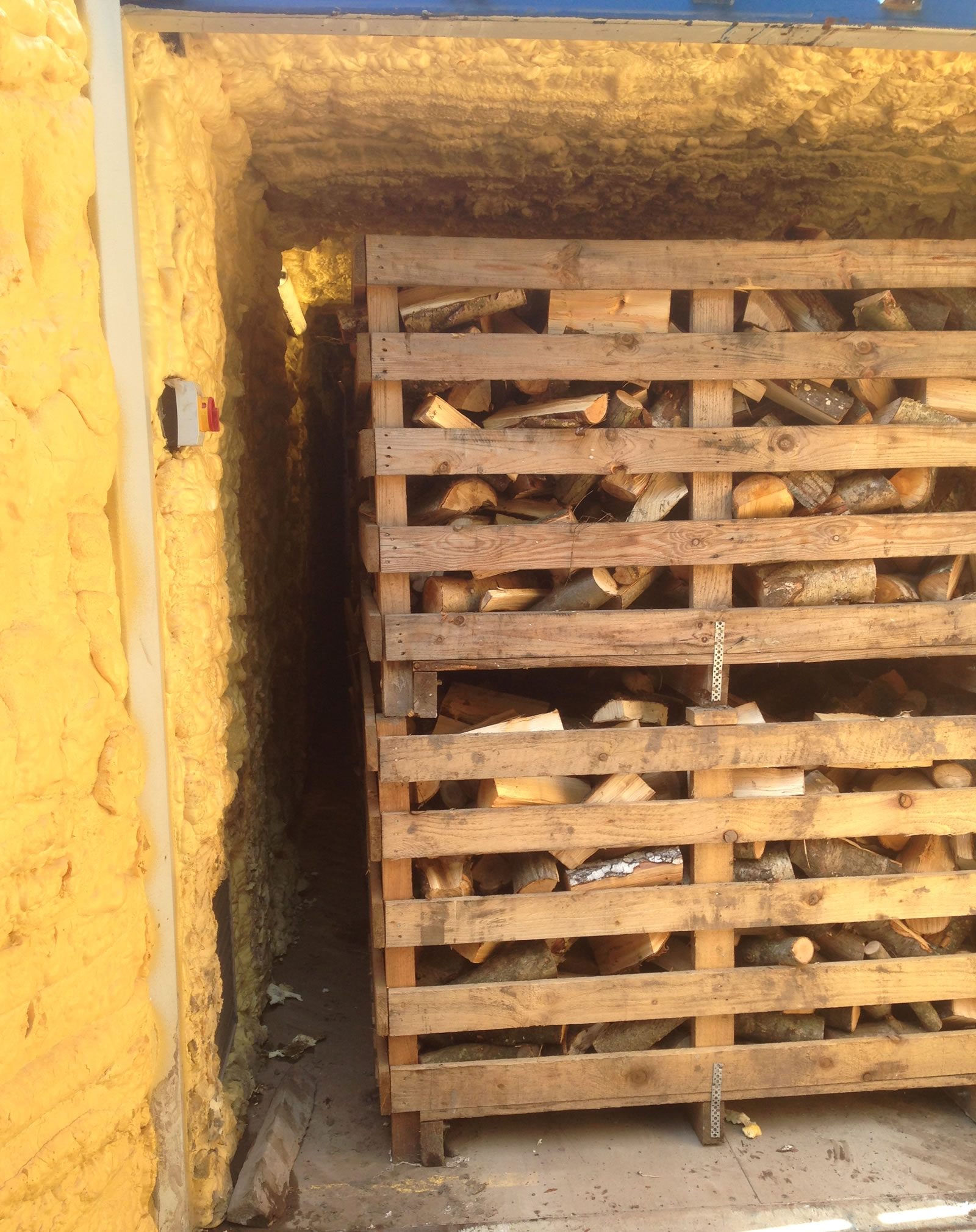 Logs drying in a crate in the kiln 